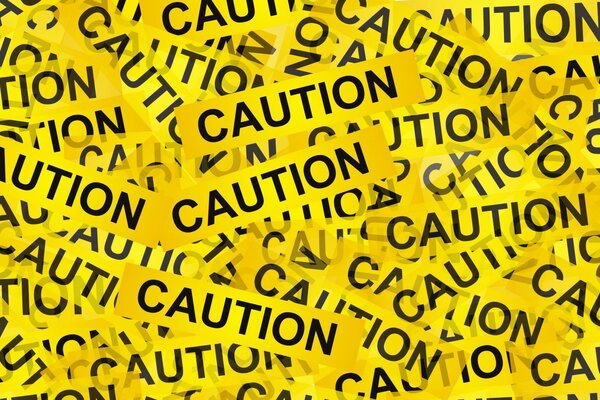 Tekst Caution na całym ekranie