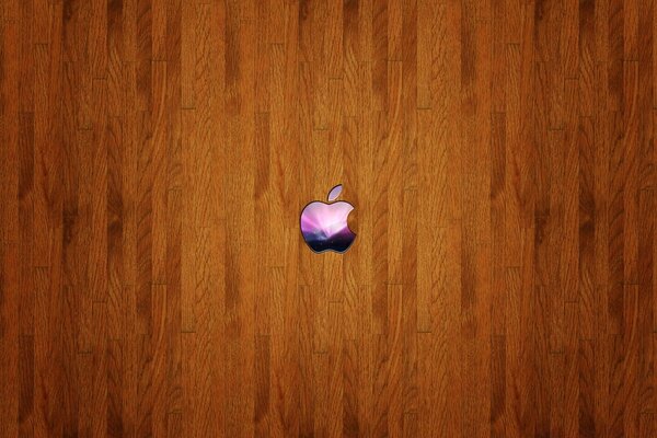 Mała kolorowa ikona Apple na drewnianym tle